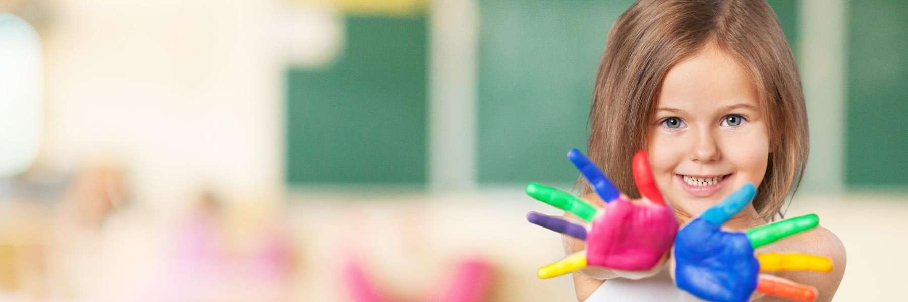 A smiling girl with painted hands